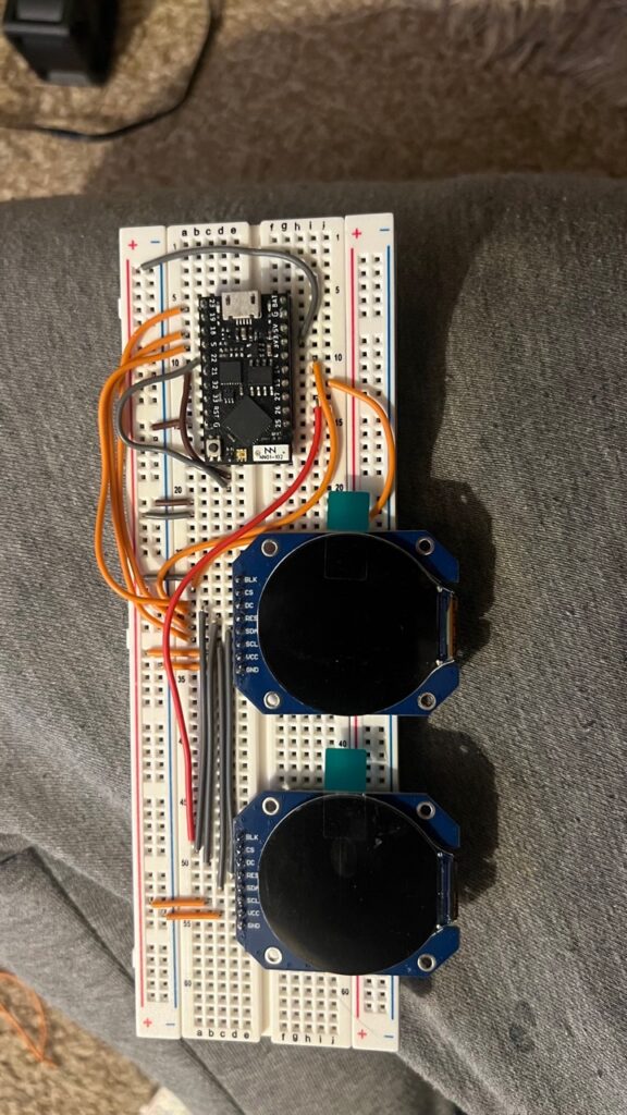 Early breadboard test with a small ESP32 board and two round LCD displays