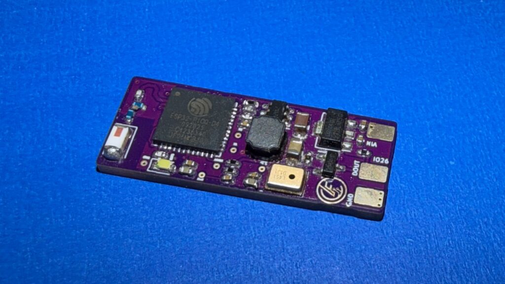 Assembled purple revision-two Micro WLED controller PCB on a blue work surface